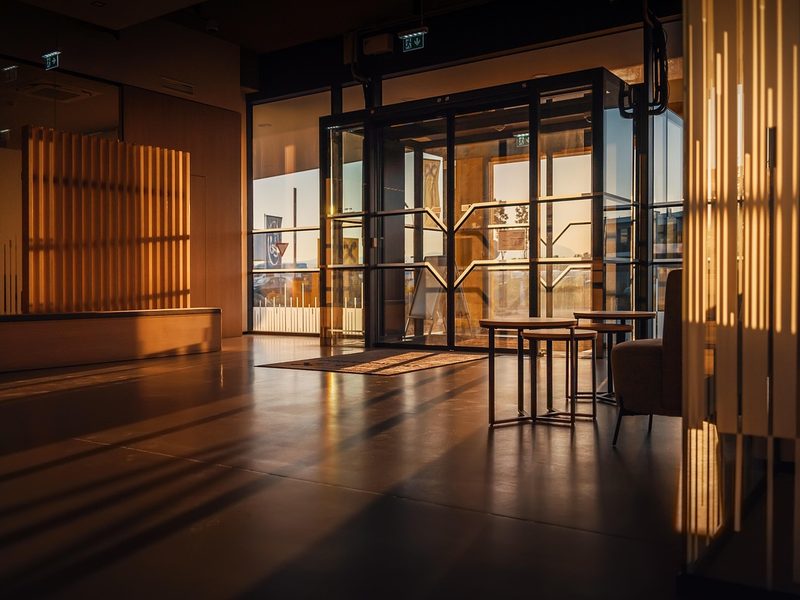 Modern office atrium at dusk — the client reception venue