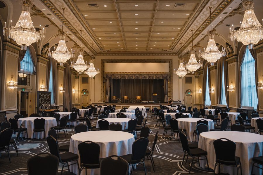 Chandelier ballroom with round tables — a typical corporate casino night venue